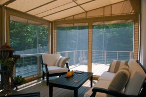 Tan deck canopy with curtains and deck furniture.
