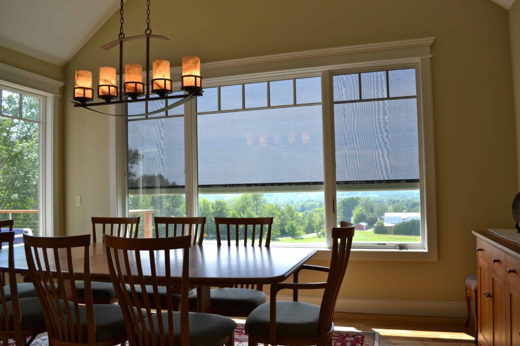 Photo of a dining room and the ability to see through mesh fabric on an exterior solar shade.
