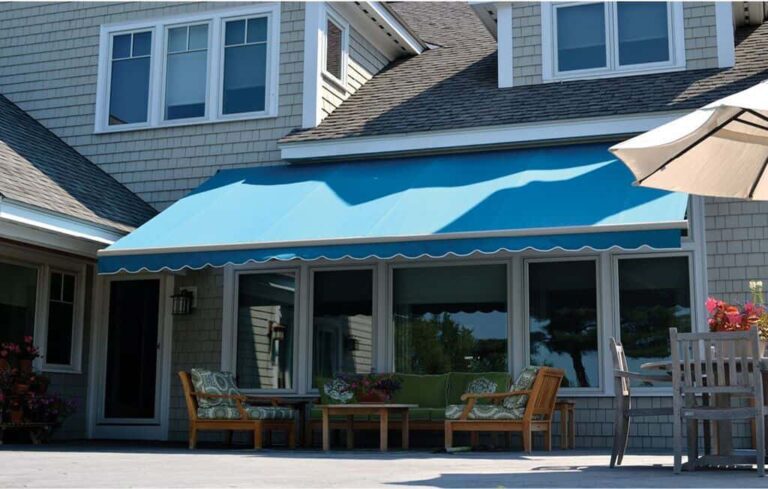 Teal retractable awning over deck.