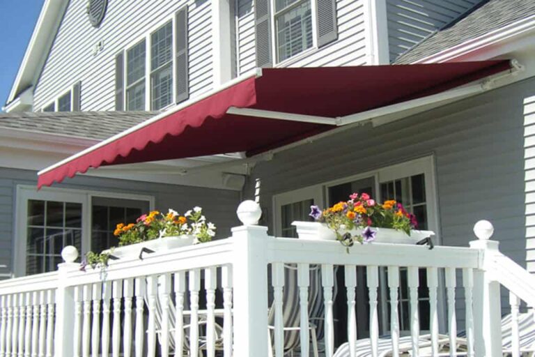 Red retractable awning over deck with flower boxes.