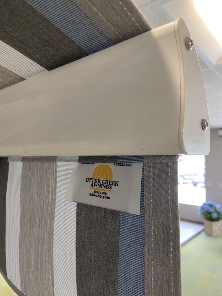 Photo of valance on an awning with an Otter Creek Awnings tag.